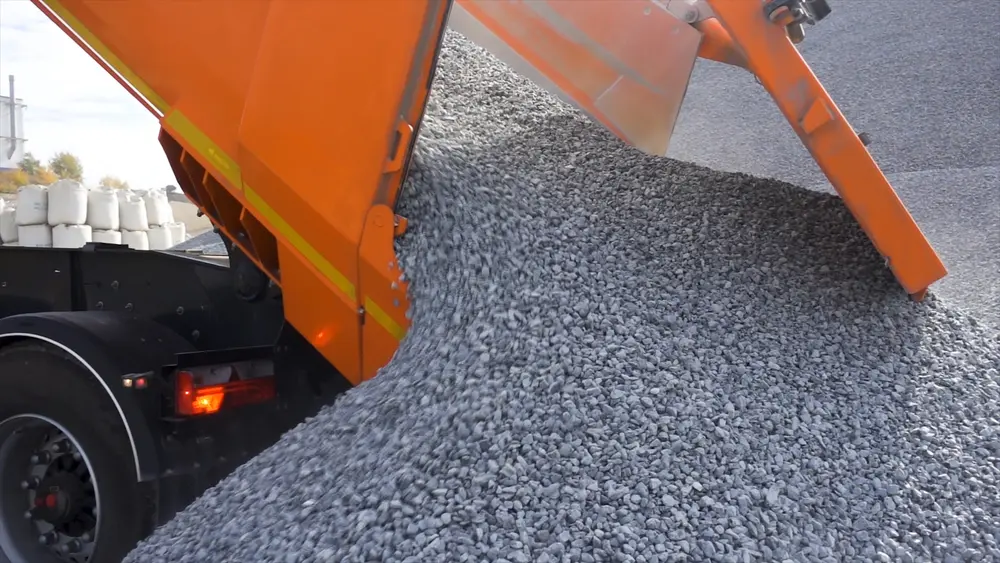 Truck unloading gravel for driveway.