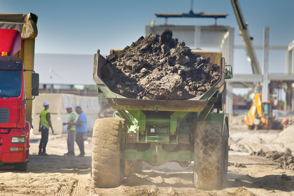 Rear view of loaded truck carrying out soil from construction site at Bonner Springs, KS