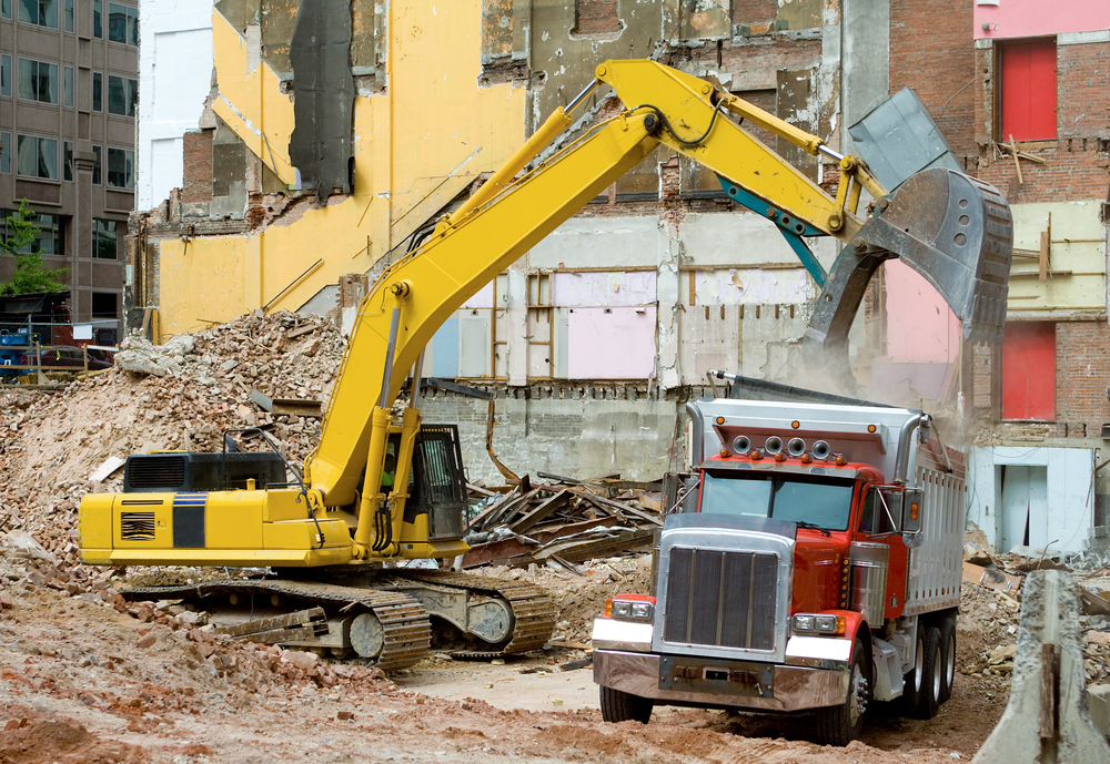 Dump truck being loaded with demolition debris for hauling